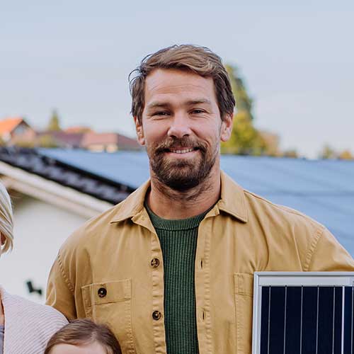 Family with solar panel outdoors.